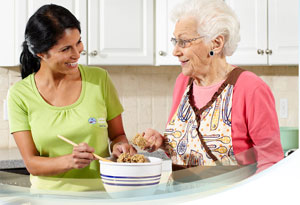 Comfort Keepers caregiver helping in the kitchen