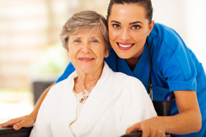 happy senior woman and caregiver